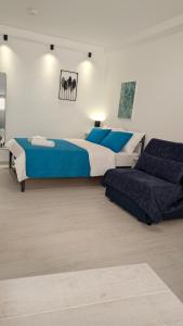 a large bedroom with two beds and a couch at Christina's Studio in Kalabaka