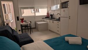 a kitchen with a couch and a table in a room at Christina's Studio in Kalabaka
