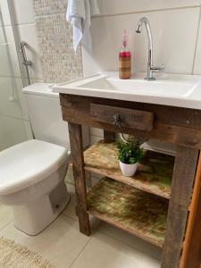 a bathroom with a sink and a toilet at Refúgio Familiar Kingdom in Tramandaí +31 photos