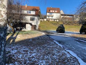 an empty street with snow on the ground next to a building at Gemütliche Wohnung mit Berg- und Waldblick in Balingen
