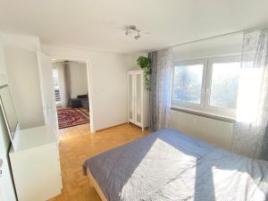 a bedroom with a bed and a large window at Gemütliche Wohnung mit Berg- und Waldblick in Balingen