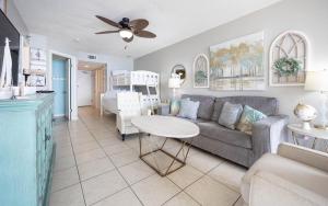 a living room with a couch and a table at Phoenix East II 2092 in Orange Beach