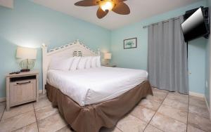 a bedroom with a large bed and a ceiling fan at Phoenix East II 2092 in Orange Beach +30 photos