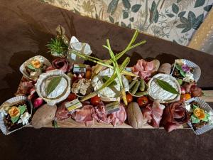 a tray of different types of food on a table at Bulle au Fil de l'eau in Romilly-sur-Andelle