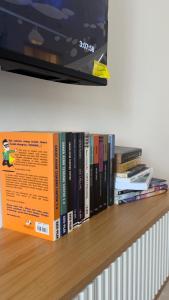 a shelf with a bunch of books on it at NHI Home Paka in Paka
