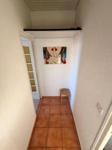 a hallway with a chair and a painting on the wall at Chez Theo in Marseille +10 photos