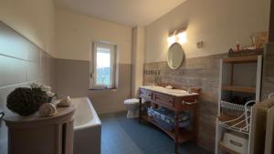 a bathroom with a sink and a tub and a toilet at Le Pré en Bulles in Chiny +34 photos