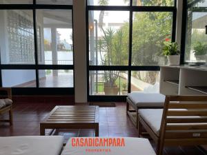 a room with tables and chairs and large windows at Casa di Campara Almada Villa in FAO +4 photos