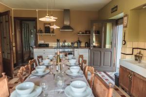 a kitchen with a table with dishes on it at Le Pré en Bulles in Chiny