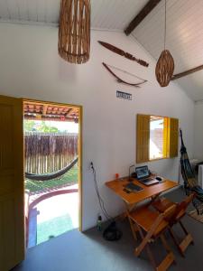 an office with a desk with a laptop on it at CARAÍVA House in Caraíva +25 photos