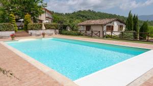 a swimming pool in front of a house at Casa al Vento in Talla