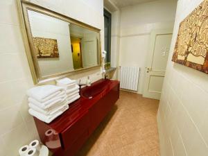a bathroom with a red sink and a mirror at La Casa di Amici Miei in Cremona +11 photos