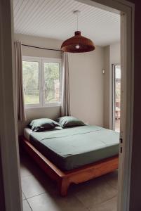 a bedroom with a large bed in front of a window at Villa Massy in Rivière-Salée +100 photos