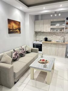 a living room with a couch and a table at Panorama Apartments in Prinos