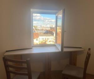 a window with a view of a city at Студія в центрі міста , 7 поверх без ліфту in Ivano-Frankivsk