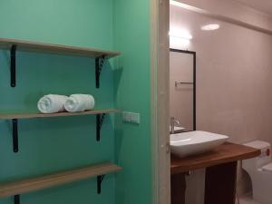 a bathroom with a white sink and a mirror at Bann Mangkud Khaolak in Khao Lak +125 photos