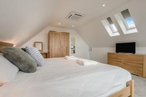 a bedroom with a large white bed and a tv at 2 Bed in Tintagel oc-g33170 in Tintagel