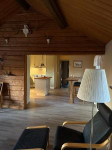 a living room with a couch and a table at Åker Lilläng Solviken in Skillingaryd +9 photos