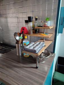 a kitchen counter with a table with food on it at Appartement avec Terrasse à Beaurivage in Biarritz +18 photos