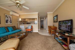 a living room with a couch and a tv at Maalaea Kai Resort 213 in Wailuku