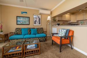 a living room with a couch and a table at Maalaea Kai Resort 213 in Wailuku