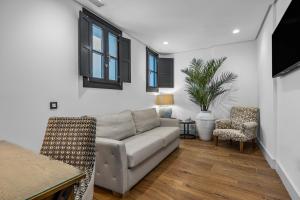 a living room with a couch and a table at VILLTAK La Maison Hotel - Adults Only Recommended in Marbella