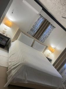 a bedroom with a white bed and a window at Steps Away from Adventure -2bedroom & 2 Bath in Turtle Cove