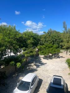 two cars parked in a parking lot with trees at Steps Away from Adventure -2bedroom & 2 Bath in Turtle Cove +8 photos