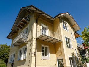 a large yellow building with a balcony on it at Loft am Wappach in Bayerisch Gmain