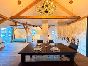 a dining room with a table and a bedroom at Loft am Wappach in Bayerisch Gmain