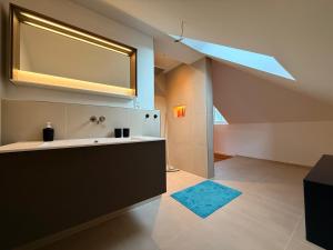 an attic bathroom with a sink and a mirror at Loft am Wappach in Bayerisch Gmain