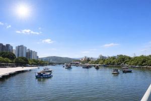 a group of boats in a river in a city at Flat Blue Praia de Camburi in Vitória