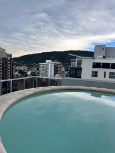 a large swimming pool on the roof of a building at Depto centro in Villa Carlos Paz +3 photos