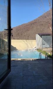 a view of a pool from a window at A frame abdul in Quba