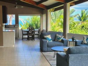 a living room with two blue couches and a table at Superbe Zions Hill Views in Sion Farm