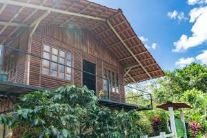 a wooden house with awning on top of it at Cabañas Retiro Del Rio in Guayabal +48 photos