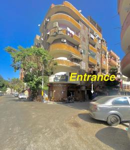 a building with the word entrance written on it at Jme Bunks Hostel in Aswān