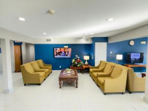 a waiting room with chairs and a table in a hospital at Americas Best Value Inn and Suites Ada in Ada