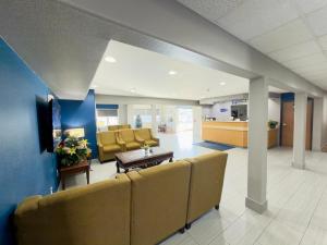 a waiting room in a hospital with chairs and a table at Americas Best Value Inn and Suites Ada in Ada