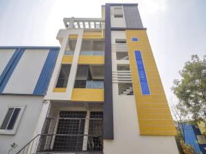 a building with yellow and blue paint on it at Hotel O Home RBS Homes in Hyderabad