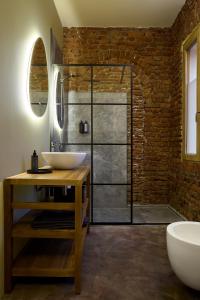 a bathroom with a sink and a glass shower at La SERAFINA in Vanzaghello