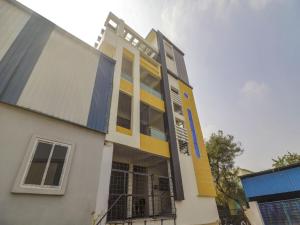 a building with yellow and blue paint on it at Hotel O Home RBS Homes in Hyderabad +38 photos