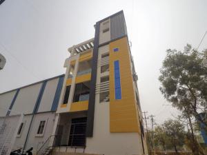 a building with yellow and blue stairs on it at Hotel O Home RBS Homes in Hyderabad