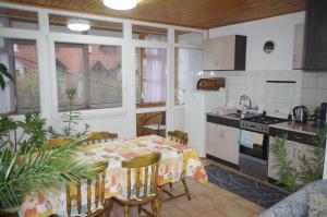 a kitchen with a table and a kitchen with a stove at Heppház in Harkány