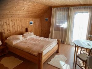 a bedroom with a bed and a table and a window at Haus Bergblick in Größing