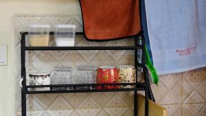 a shelf in a room with jars on it at Coral Homes in Juja +7 photos