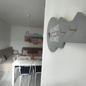 a white dining room with a table and chairs at casa MAREA in Lido Marini +17 photos