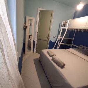a bedroom with a bunk bed and a ladder at casa MAREA in Lido Marini