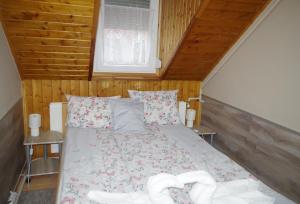 a bedroom with a bed in a wooden house at Heppház in Harkány