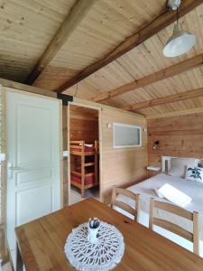 a room with a table and a bed in a room at Camping Les Rochelles in Prunay-Cassereau